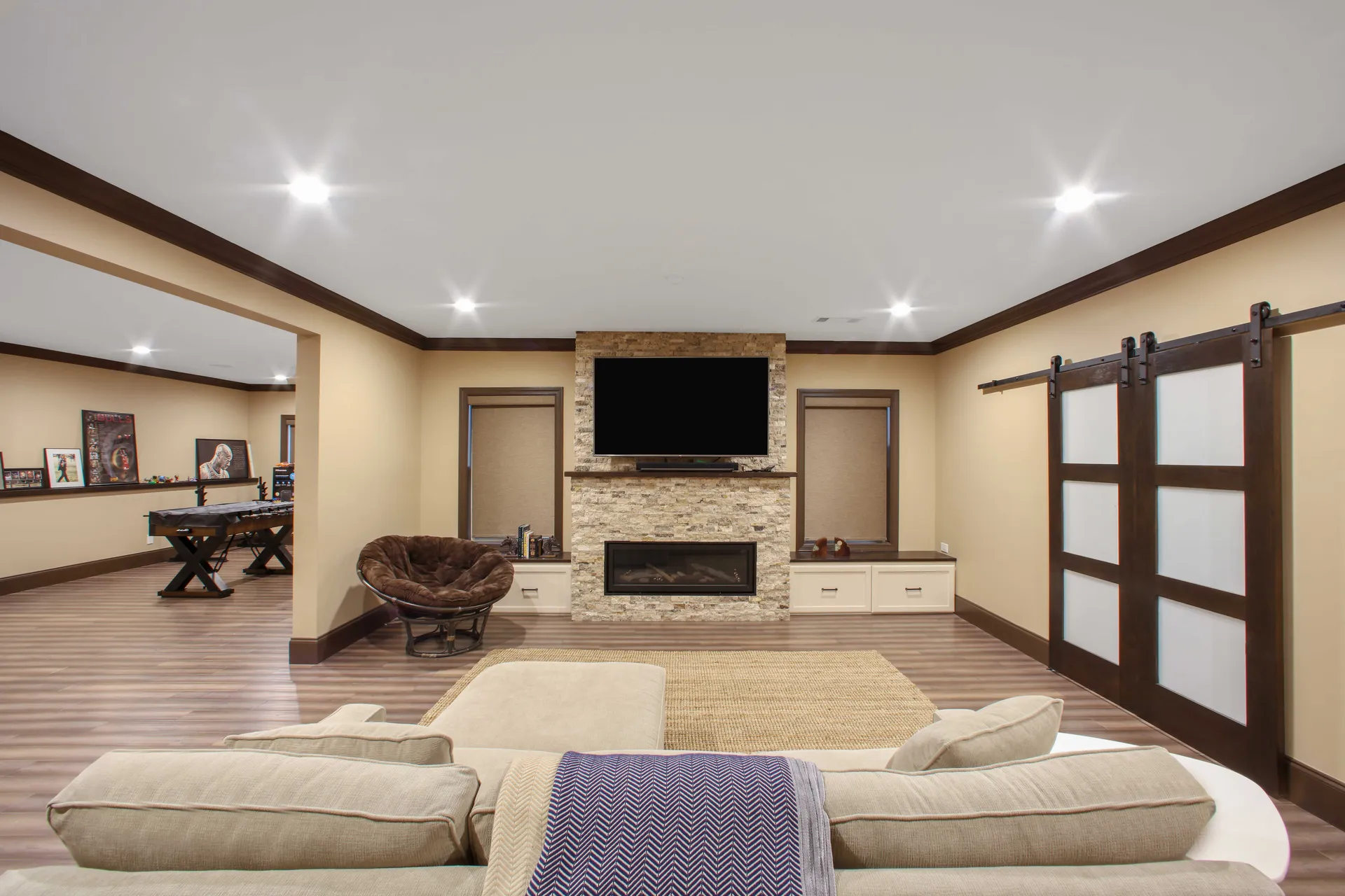 Finished basement living room with wood beams in Roswell, GA by HomeVantage