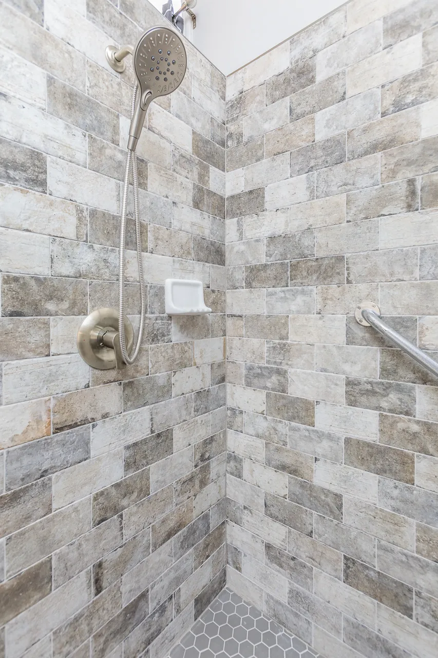 Marble tile detail in a Johns Creek, GA bathroom remodel by HomeVantage