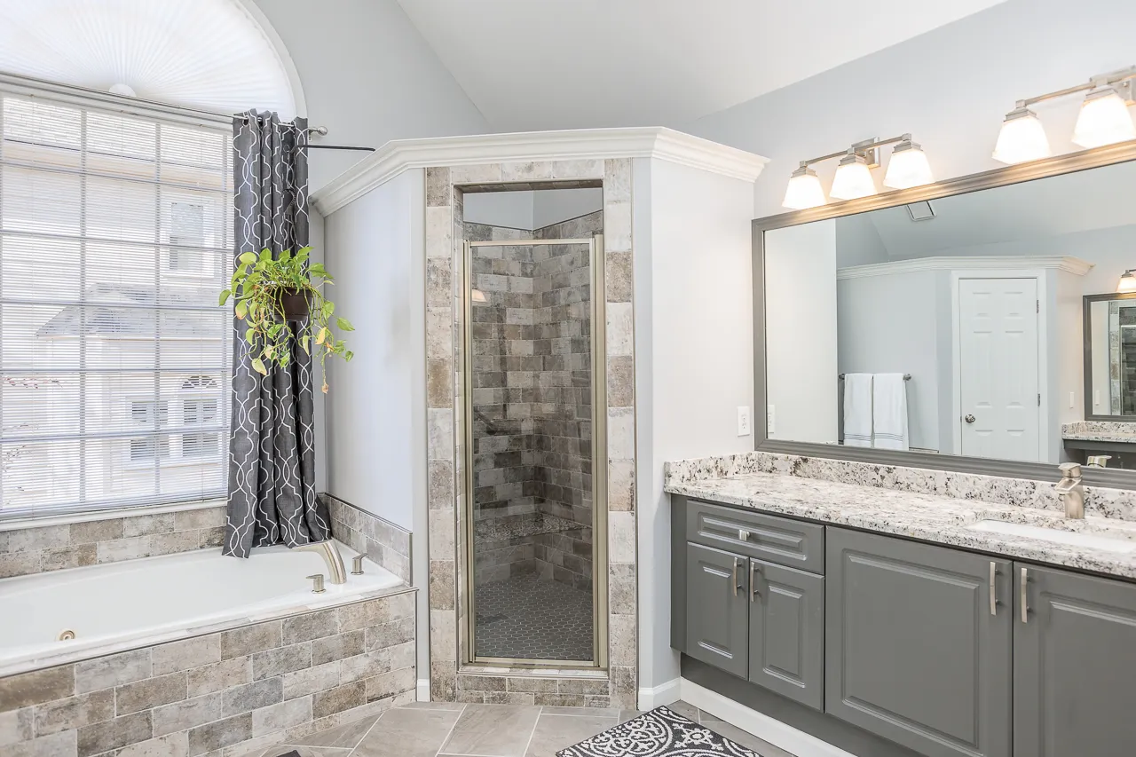 Vanity and glass shower in a remodeled Johns Creek, GA bathroom by HomeVantage