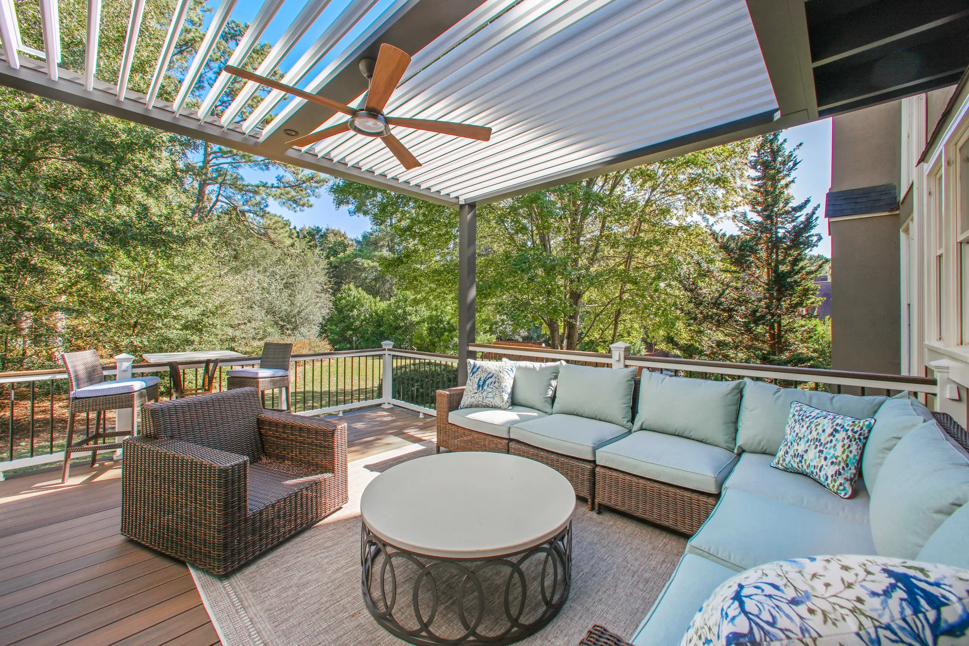 Covered deck with louvered pergola and outdoor seating built by HomeVantage in Alpharetta, GA