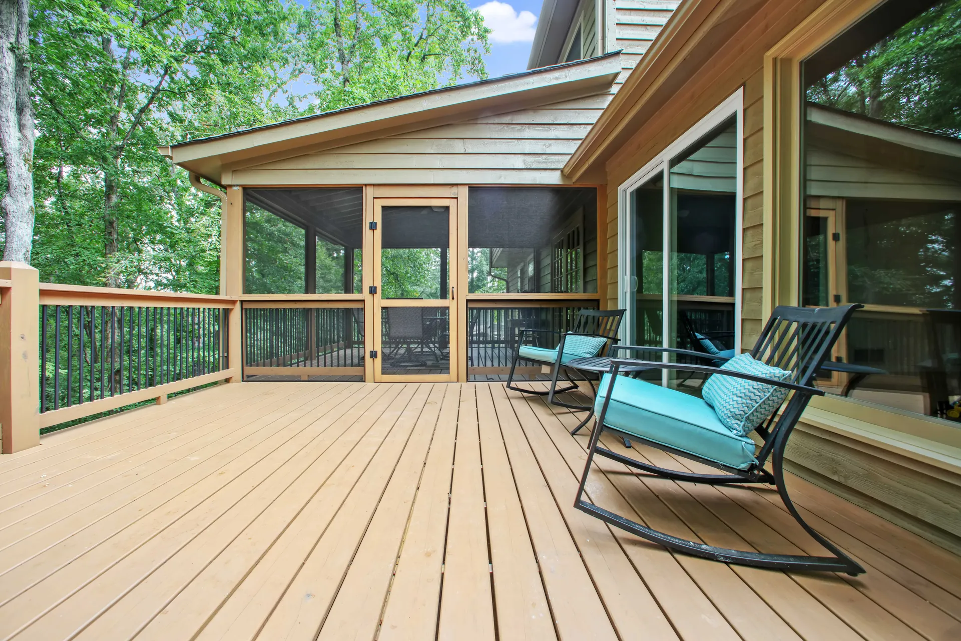 Long covered composite deck on a wooded Roswell, GA lot by HomeVantage