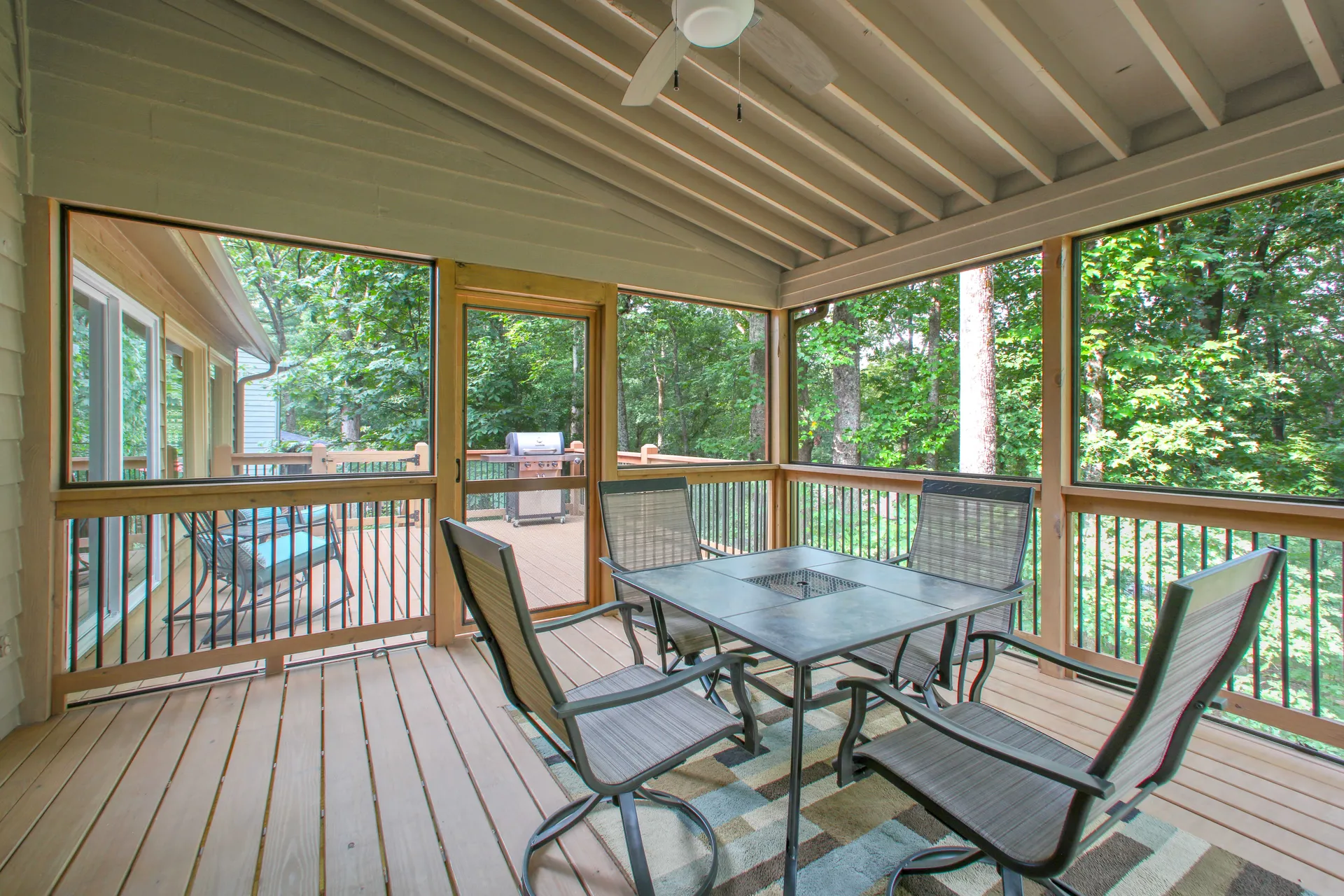 Covered deck dining area on a wooded lot in Roswell, GA, built by HomeVantage