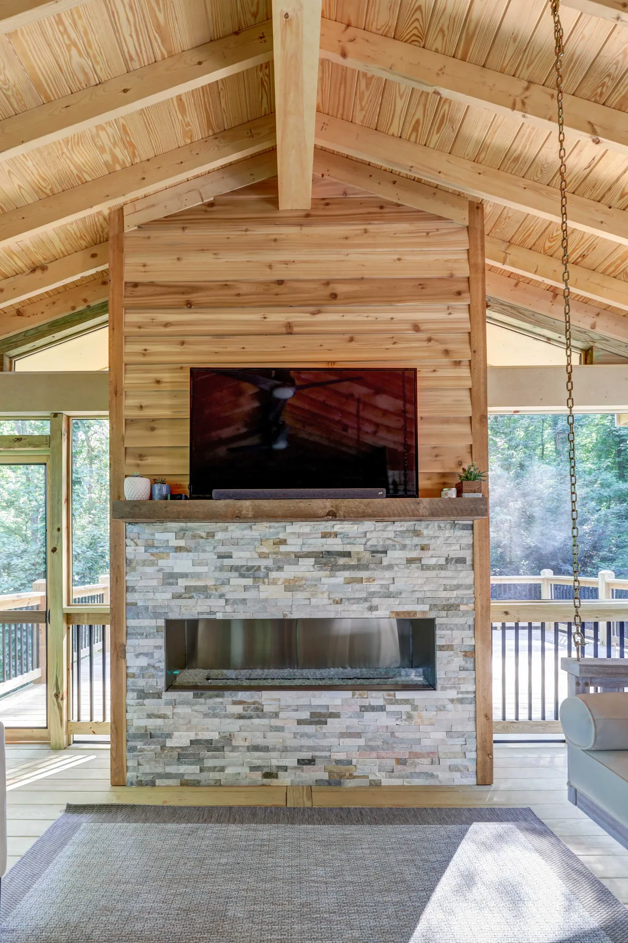 Covered deck with outdoor fireplace in Sandy Springs, GA by HomeVantage