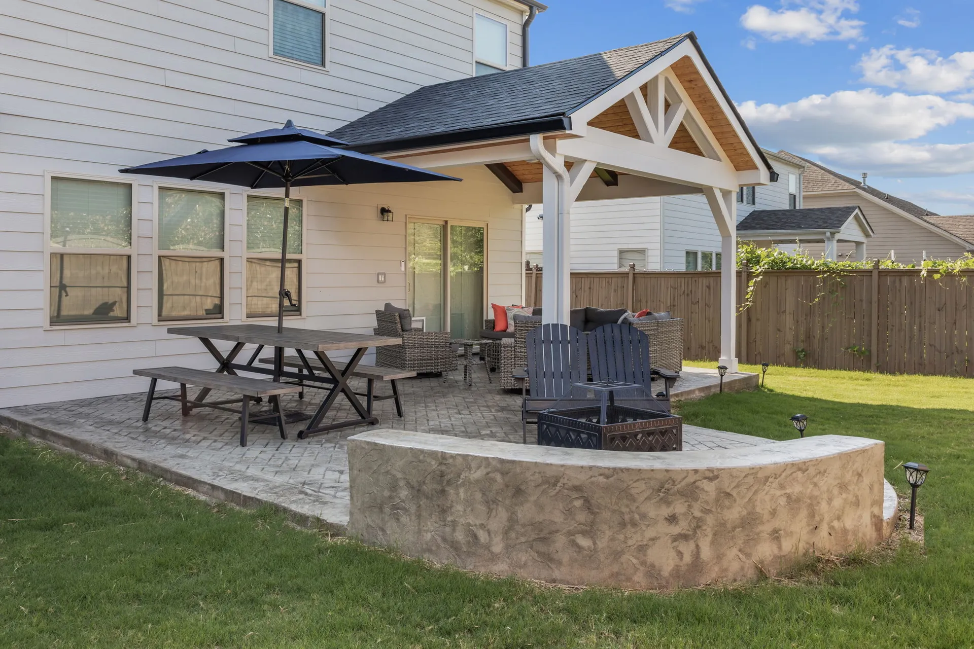 Covered patio with an outdoor kitchen in Cumming, GA by HomeVantage