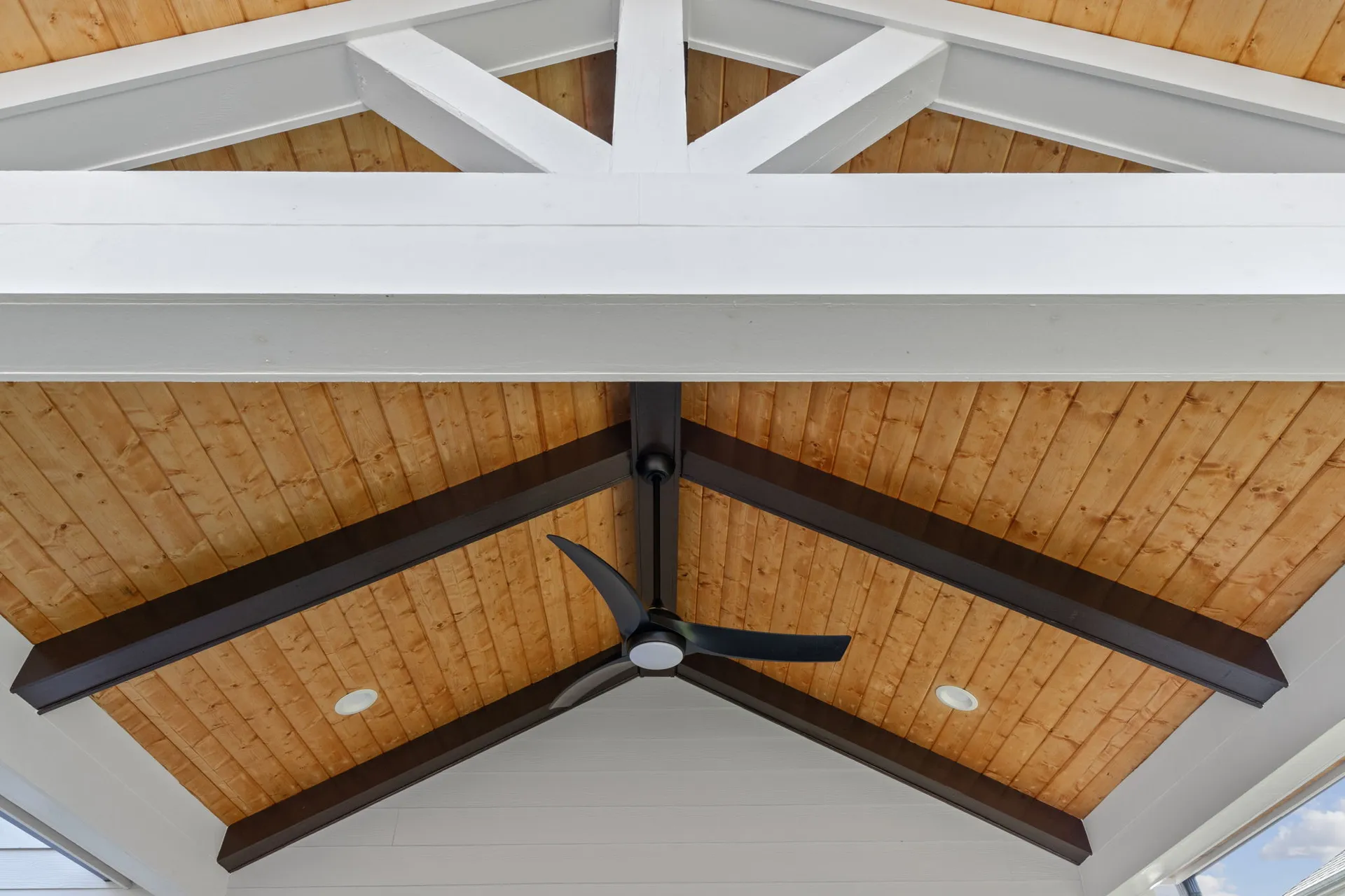 Covered patio with a vaulted wood ceiling in Cumming, GA by HomeVantage