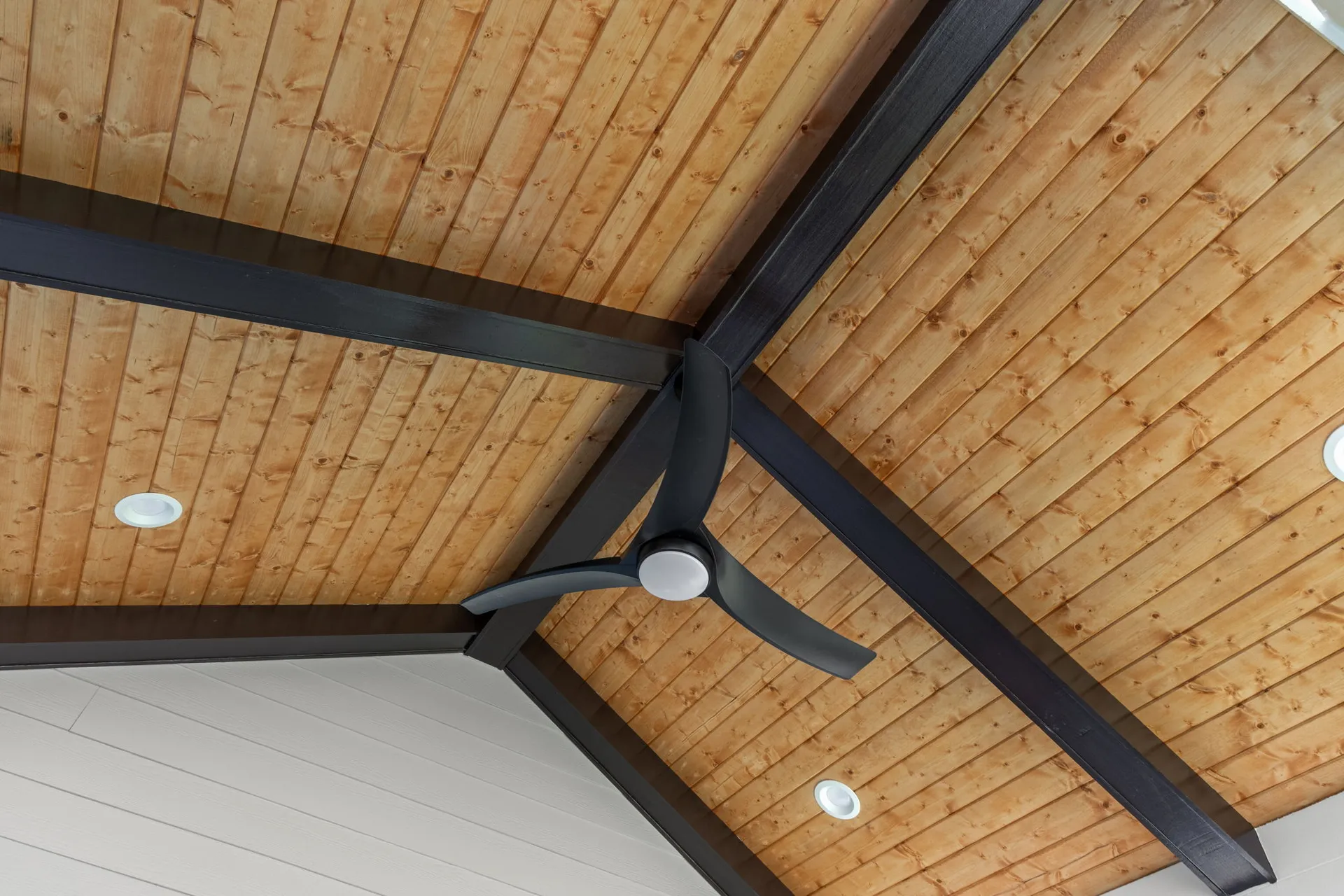 Covered patio with a vaulted wood ceiling in Cumming, GA by HomeVantage