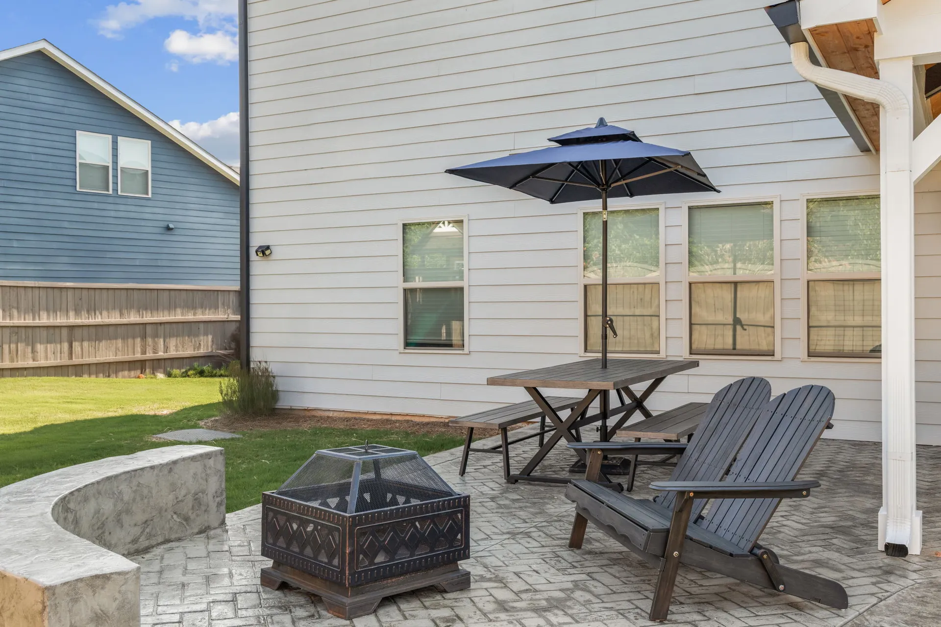 Covered patio with a fire pit in Cumming, GA by HomeVantage