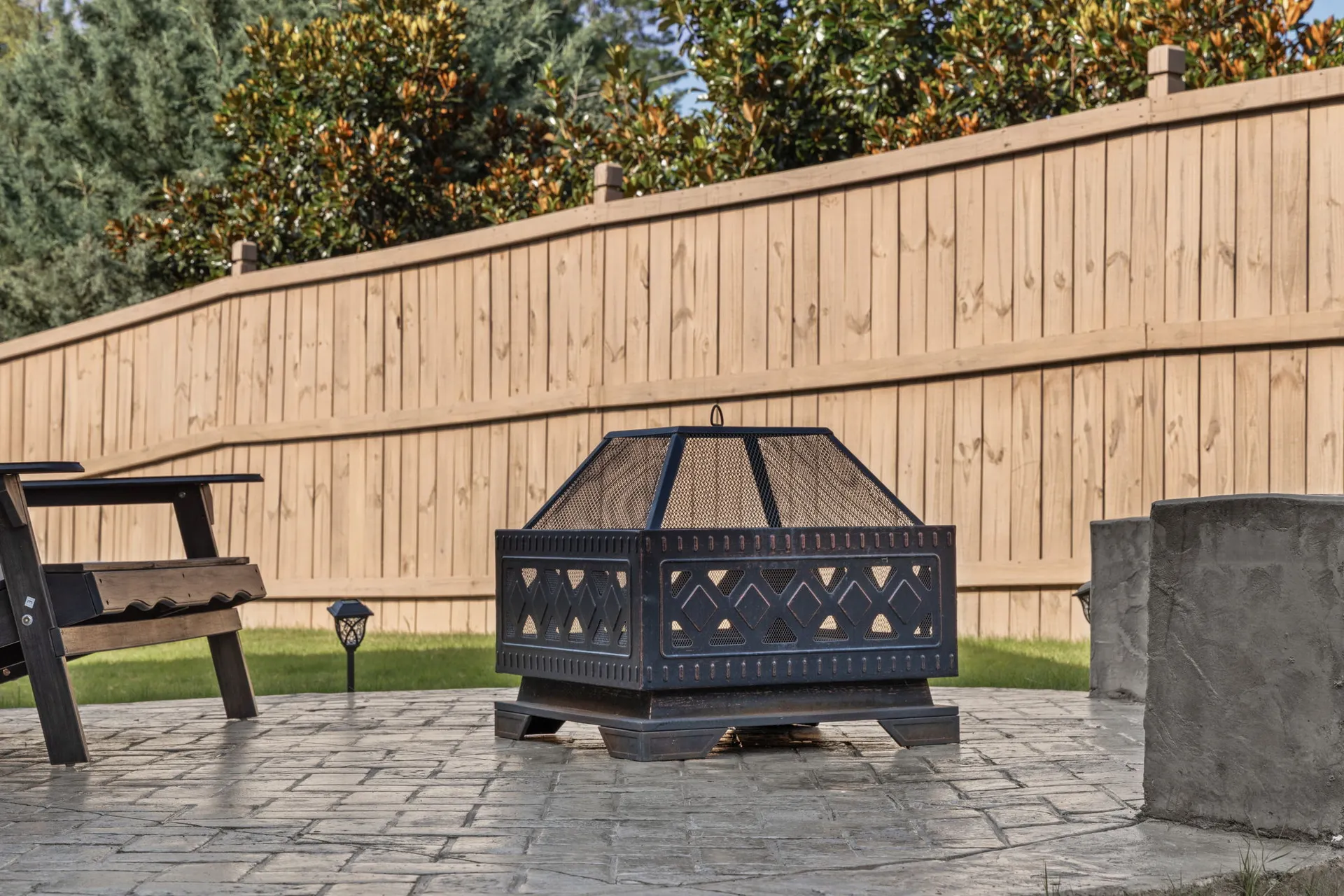 Covered patio with a fire pit in Cumming, GA by HomeVantage