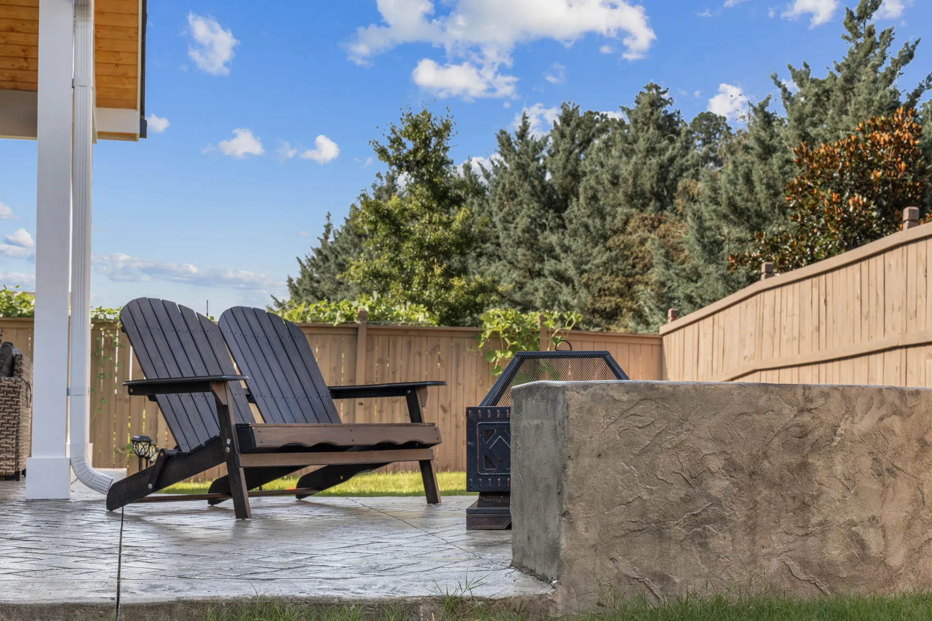 Covered patio with a fire pit in Cumming, GA by HomeVantage