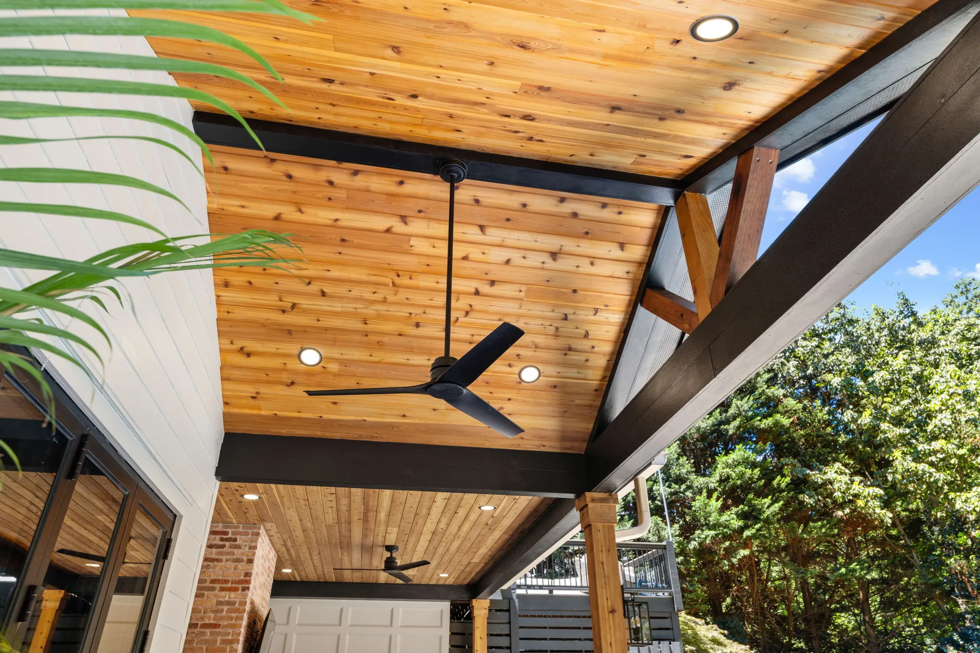 Covered patio with a vaulted wood ceiling in Cumming, GA by HomeVantage