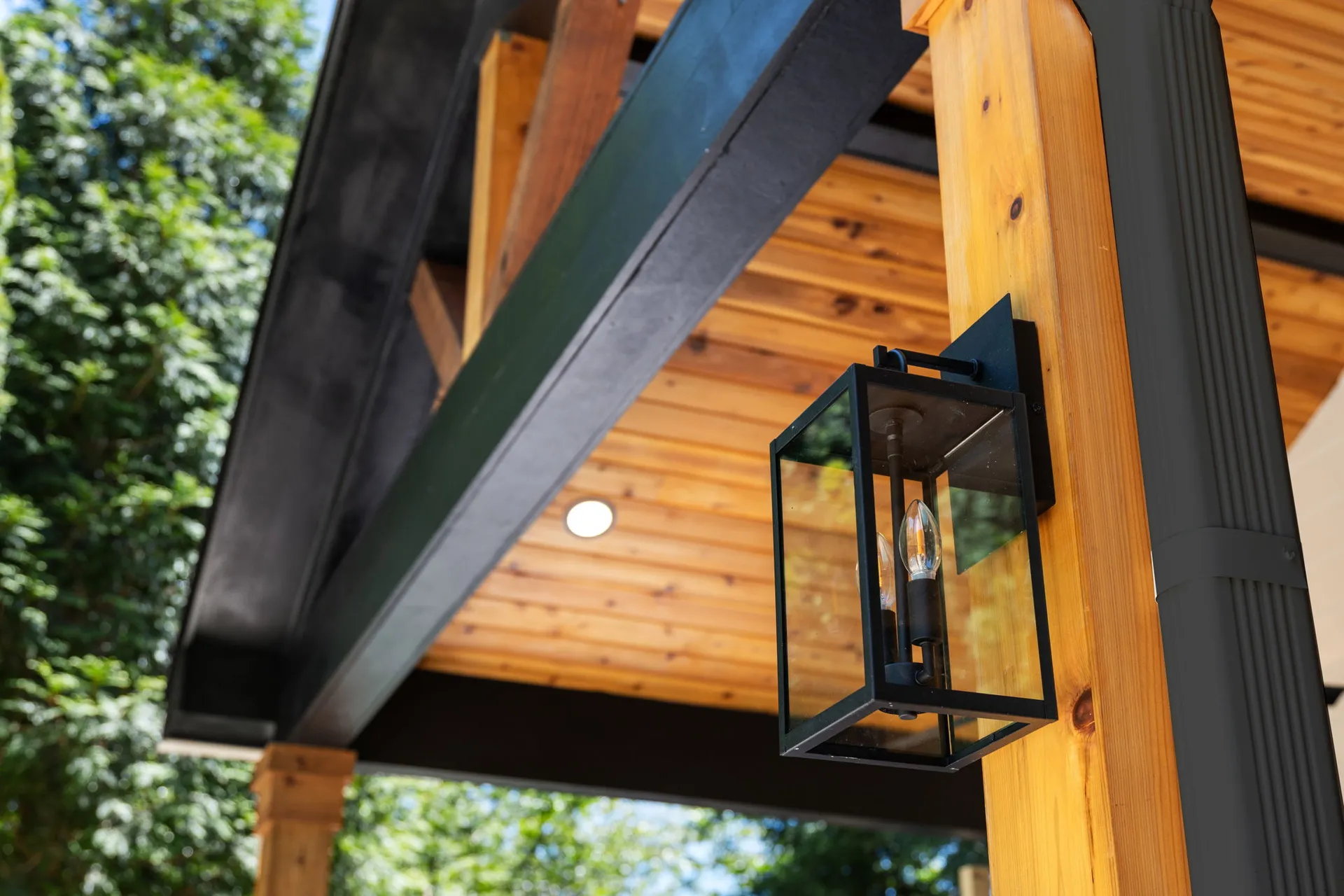 Covered patio with a vaulted wood ceiling in Cumming, GA by HomeVantage