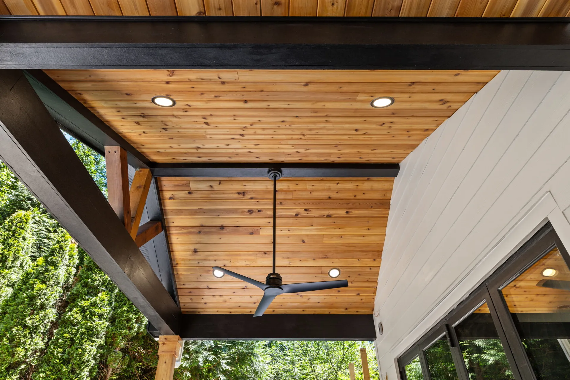 Covered patio with a vaulted wood ceiling in Cumming, GA by HomeVantage