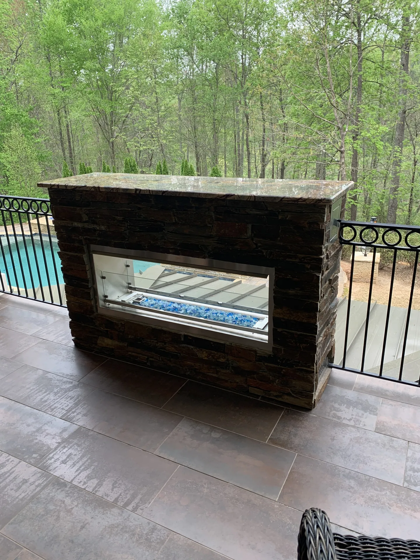 Covered patio with an outdoor fireplace in Roswell, GA by HomeVantage
