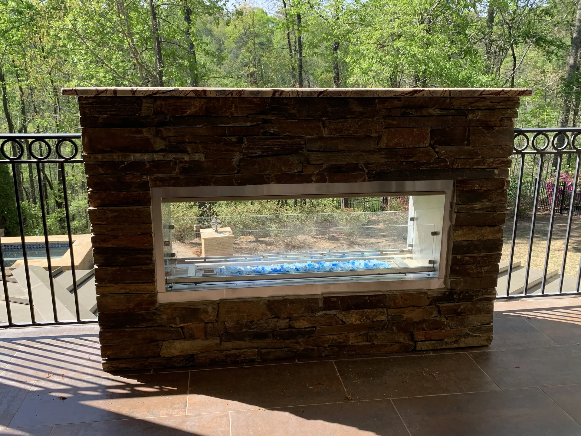 Covered patio with an outdoor fireplace in Roswell, GA by HomeVantage
