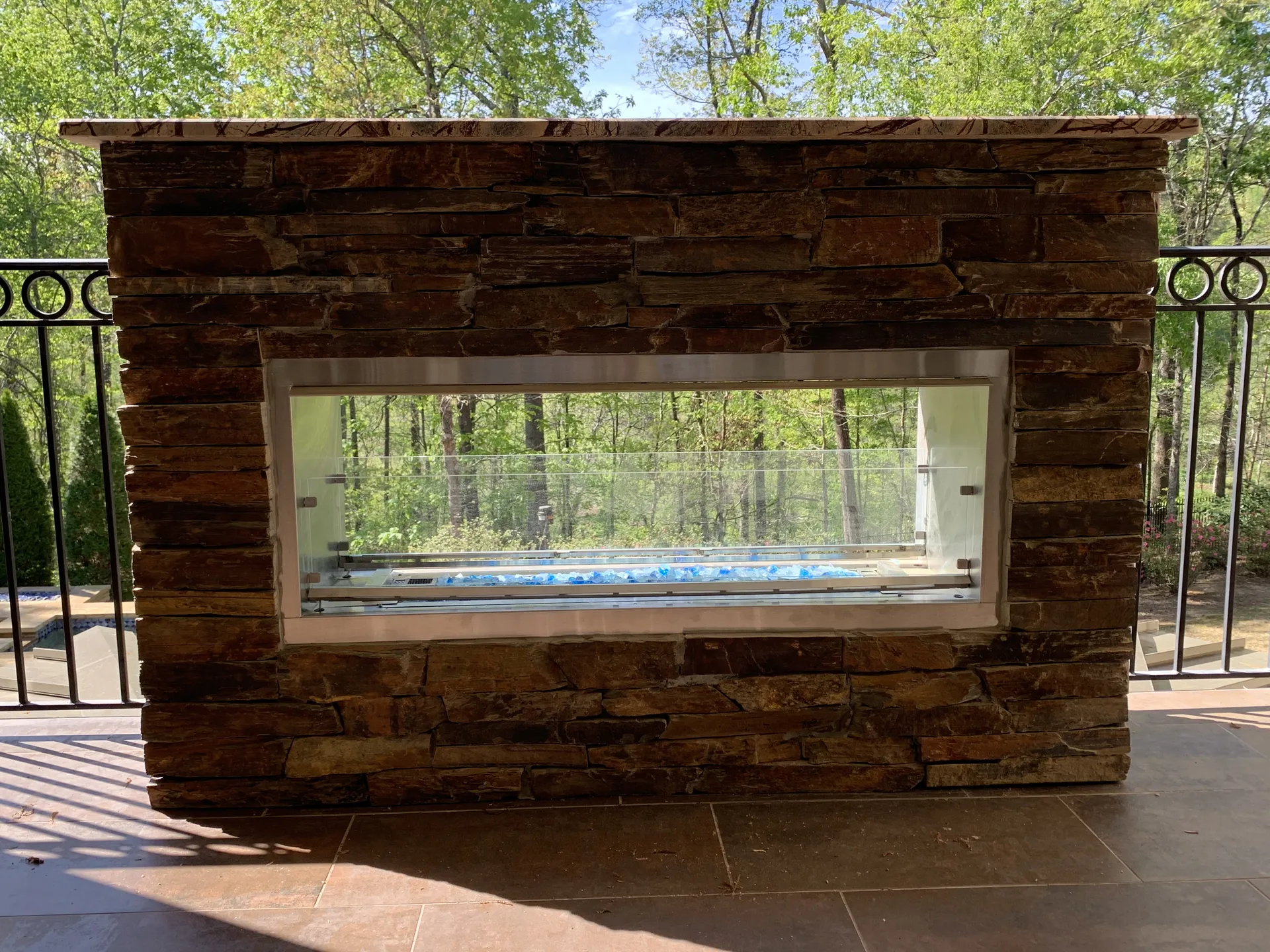 Covered patio with an outdoor fireplace in Roswell, GA by HomeVantage