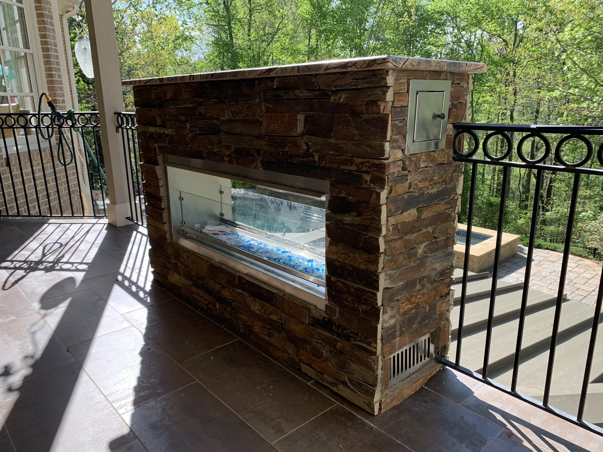 Covered patio with an outdoor fireplace in Roswell, GA by HomeVantage
