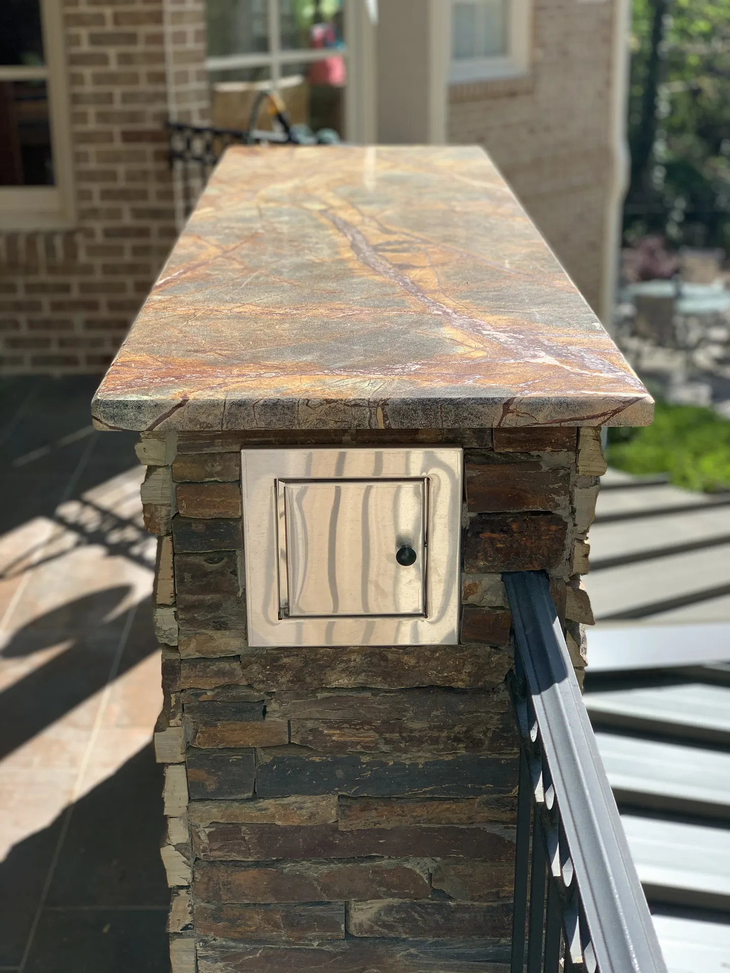Covered patio with an outdoor fireplace in Roswell, GA by HomeVantage