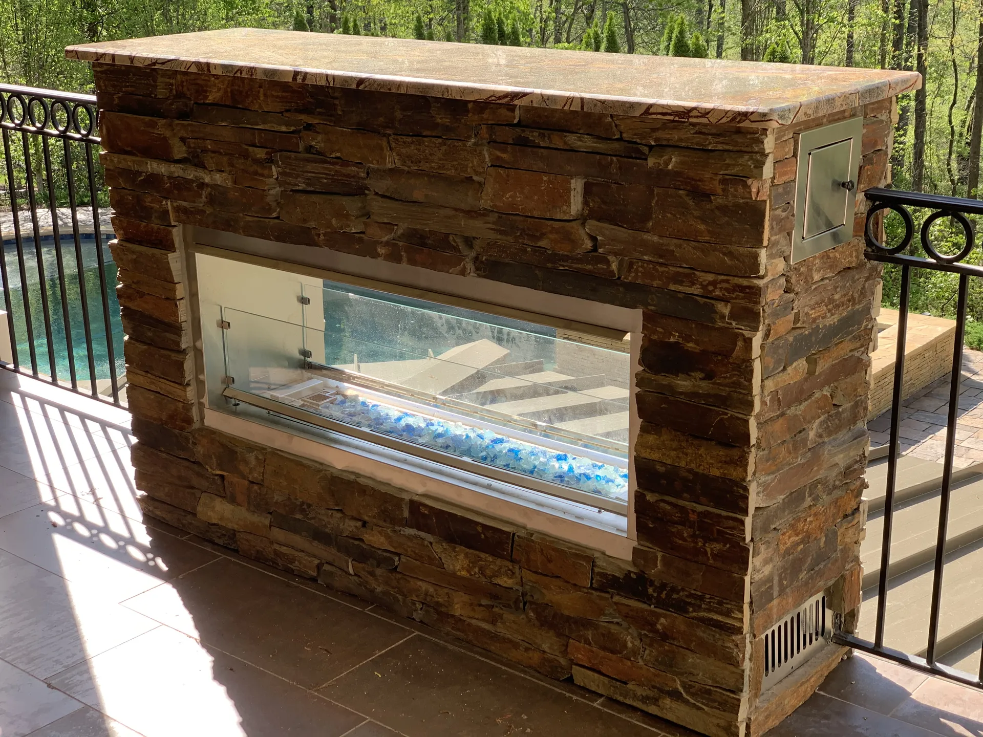 Covered patio with an outdoor fireplace in Roswell, GA by HomeVantage