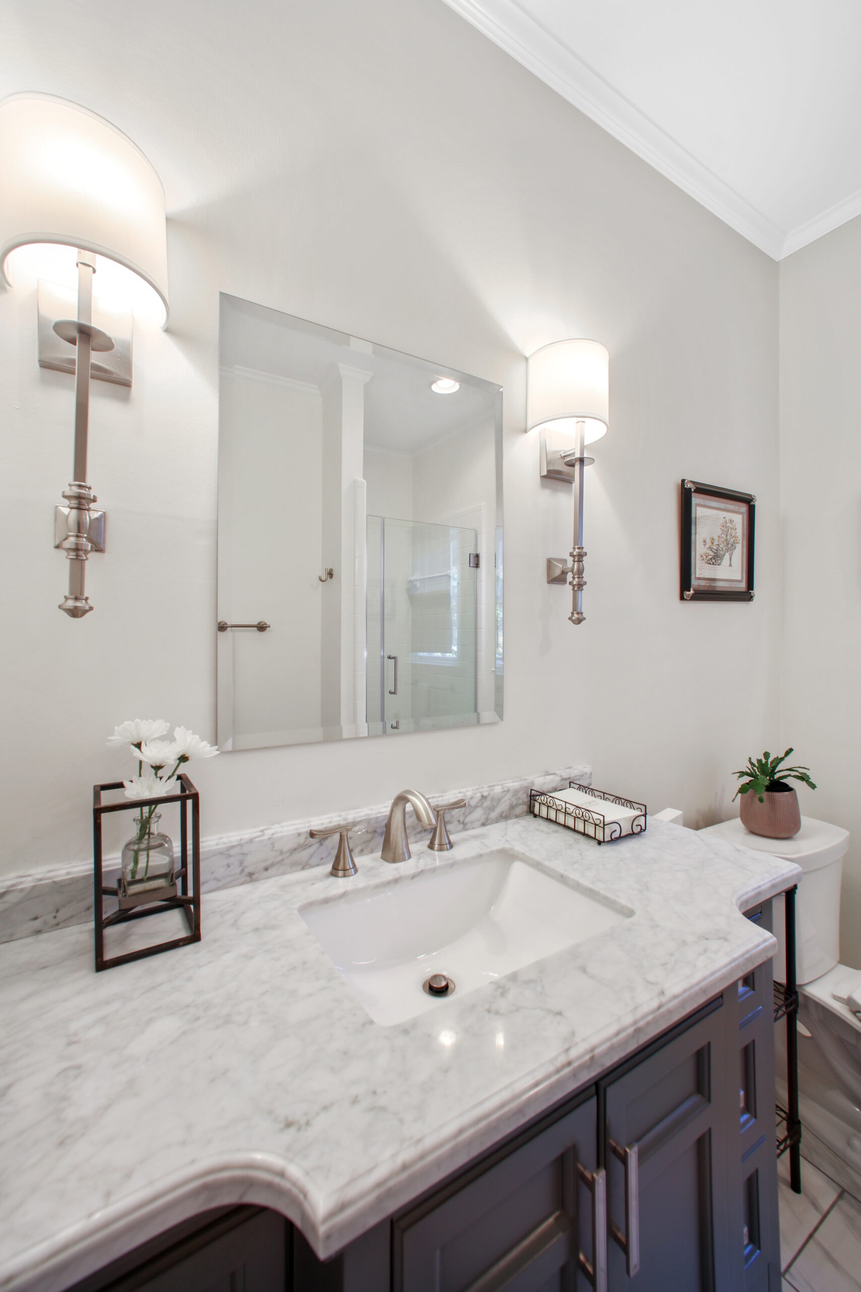 Modern bathroom with marble countertop, stylish sink, elegant fixtures, and decorative elements, showcasing HomeVantage's design expertise in home remodeling.