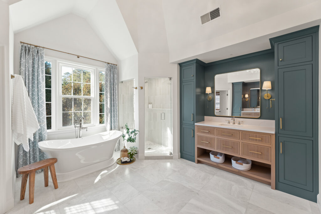 Modern bathroom design featuring a freestanding tub, elegant cabinetry, and a spacious shower area, showcasing refined finishes and natural light in a serene Alpharetta setting.